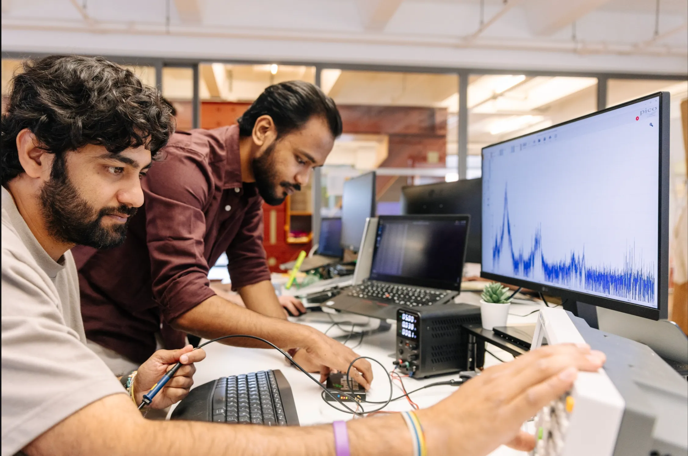 Better Devices engineers reviewing figures on screen at the bench