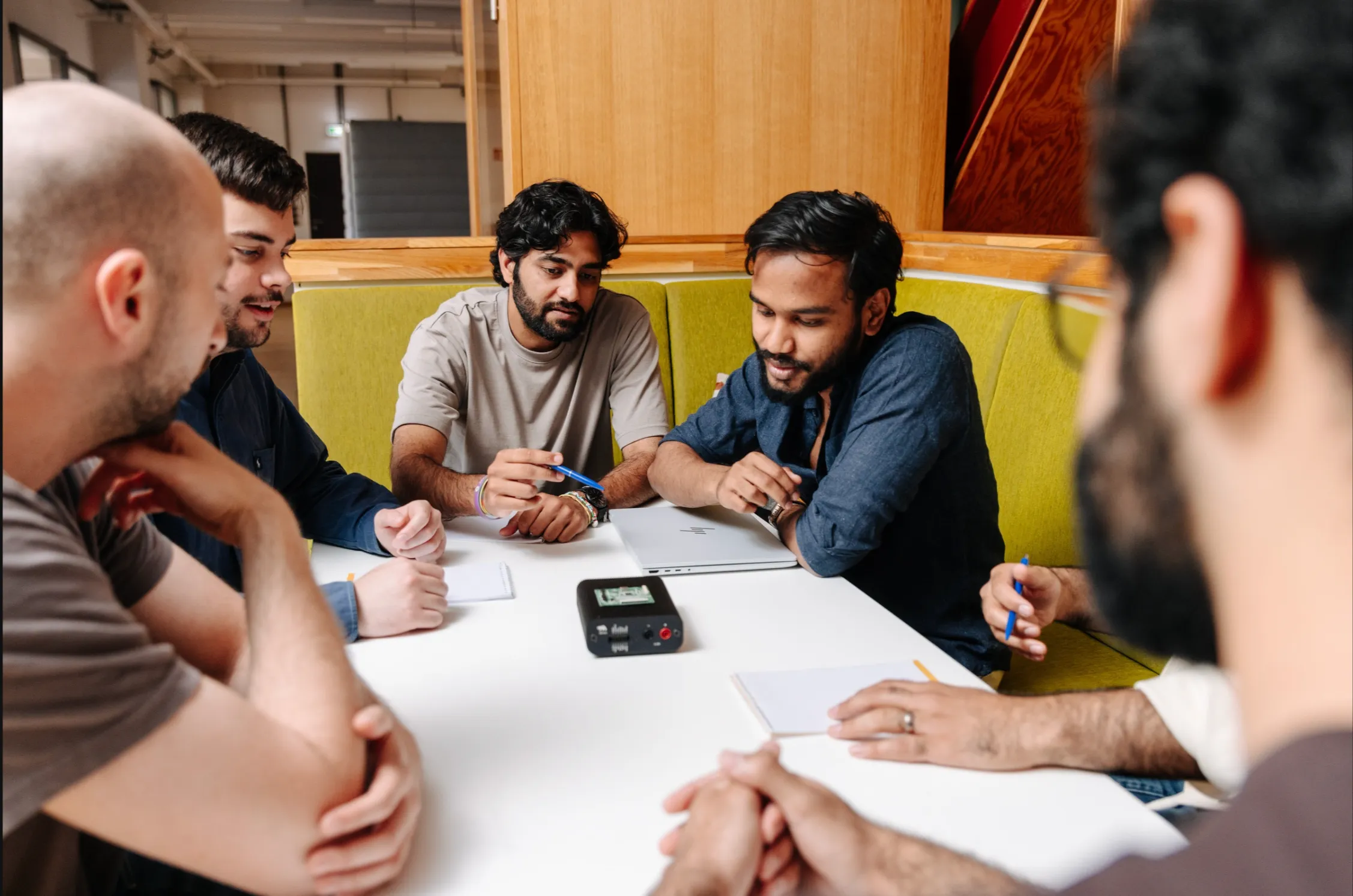 Better Devices engineers huddled around a prototype